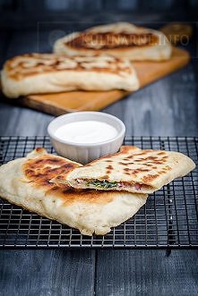 Ciasto
300 g mąki pszennej
90 ml ciepłej wody
szczypta soli
10 g świeżych drożdży
1 łyżka oliwy
Farsz
100 g sera feta
100 g liści szpinaku
5 listków mięty
1 czerwona cebula
2 zą...