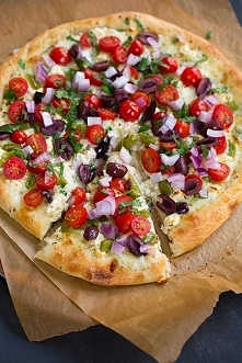 Greek Pizza - covered with feta, mozzarella, grape tomatoes, red onion, bell pepper, kalamata olives, garlic and parsley