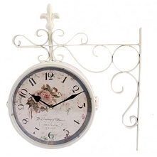 Rewelacyjny zegar dworcowy z motywem róży, o białej metalowej konstrukcji. Wyjątkowo elegancki dodatek.