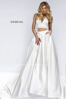 Gorgeous satin Sherri Hill prom dress 50053 showcases a halter crop top and A-line skirt with pockets embellished with coordinating color beads. This dress is perfect as a  Prom...