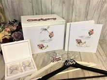 Zestaw ślubny zdobiony srebrną wstążką oraz grafiką kształt geometryczny i róże