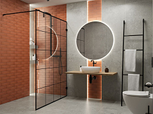 Łazienka w szarości przełamanej pomarańczową cegłą w strefie prysznicowej.