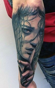 forearm face tattoo