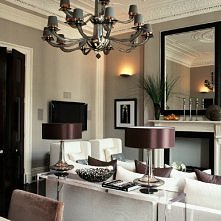 Gray & purple living room design with large black framed mirror