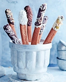 Gingerbread Sticks

Makes about 20

gingerbread dough*
7 oz chocolate (white, milk or dark)
crushed almond, chopped nuts, and sprinkles

Preheat oven to 370°F.
On a floured tabl...
