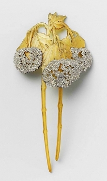 A Hair Comb of horn and gold set with diamonds, representing two Viburnum branches, by R. Lalique. France, ca. 1900.