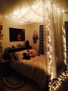 DIY Hanging Bed Canopy - Using $5 sheer white curtains from Target, removable wall hooks, and Christmas lights. Then I used clear tacks to make the curtains over head billowy. T...