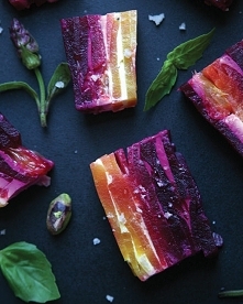 Serves 4 You will need: 12 beets, in as many different colors as you can find. 1 lb soft goat cheese salt and pepper, to taste glug of olive oil basil leaves pistachios edible f...