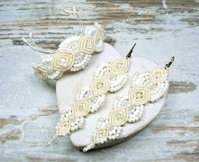 Komplet biżuterii ślubnej w odcieniach ecru oraz bieli, z przepięknie mieniącymi się szklanymi koralikami. Długie kolczyki wiszące umieszczone są biglach otwartych, ich długość ...