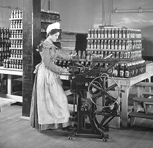 Female worker bottling ketchup at the original Heinz factory circa 1897